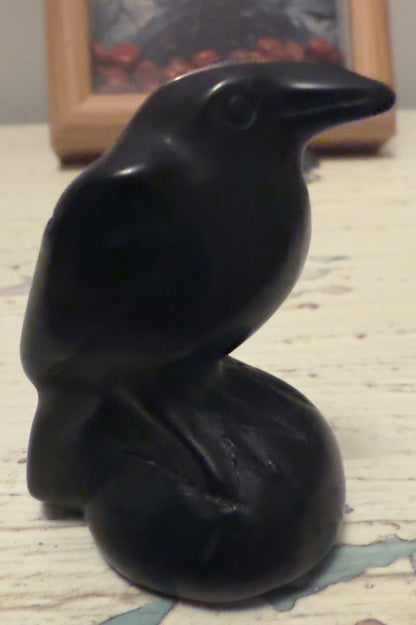 Black bird figurine with smooth, polished surface.
