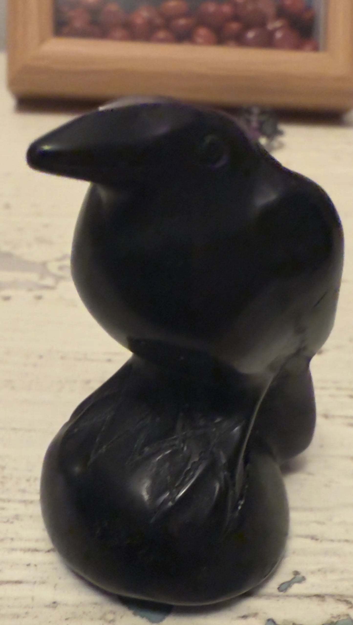 Black crow figurine sitting on a round base, part of The House on the Hill 🦇 Framed Art