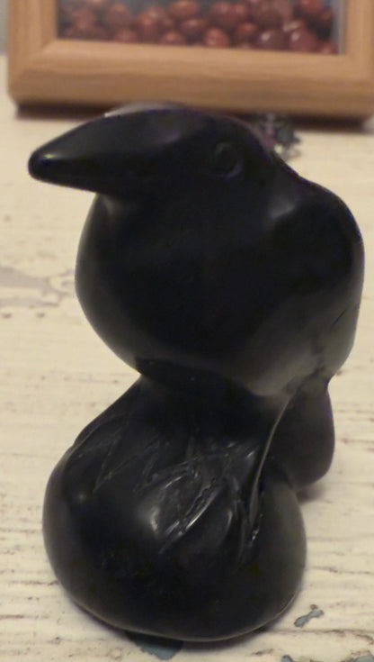 Black crow figurine sitting on a round base, part of The House on the Hill 🦇 Framed Art