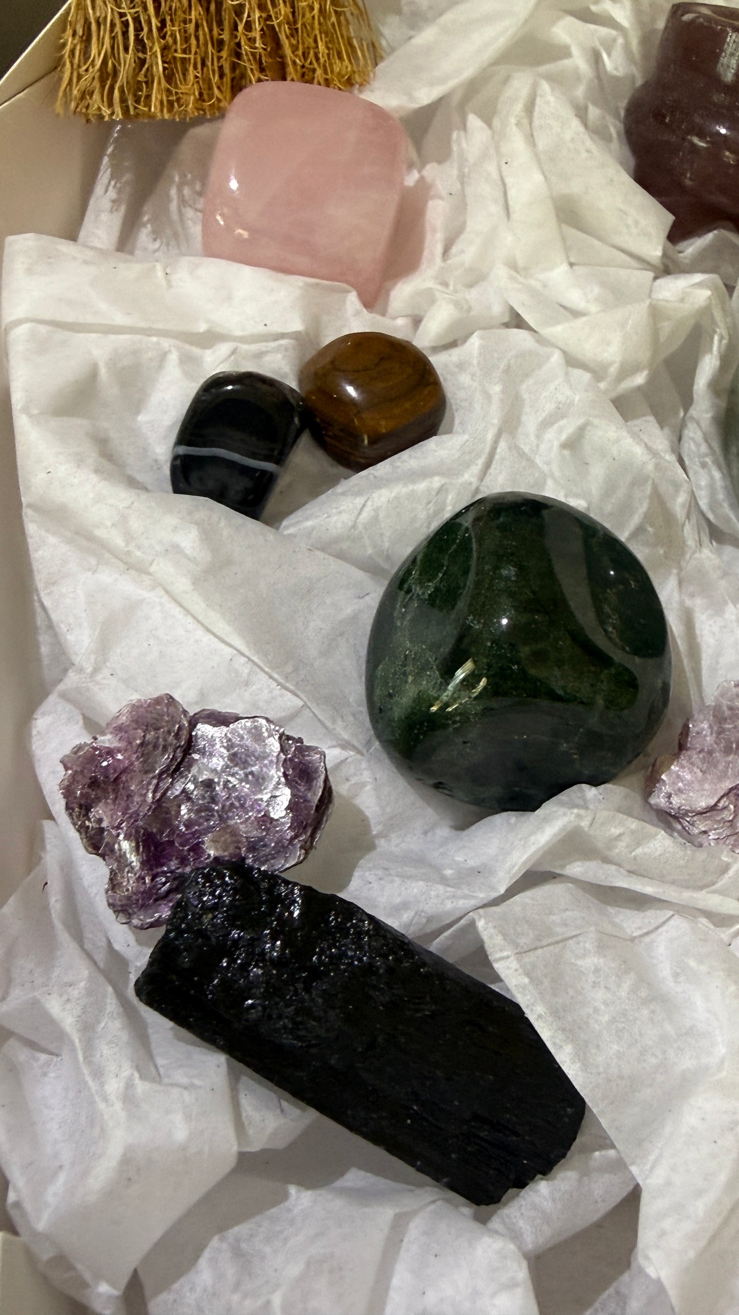 Close up of jasper, rose quartz, mica and black tourmaline crystals included in the witch’s brew set 