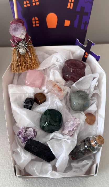 photo showing close up of all pieces in the bundle, strawberry quartz, rose quartz, green jasper, labradorite, black tourmaline, mica. Witches broom with amethyst and spider charm.  Assorted tumbles and wish bottle filled with dragon’s blood crystal chips