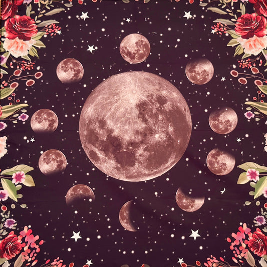 close up of moon phase altar cloth, background dark charcoal with flowers in all corners. red and pink flowers 