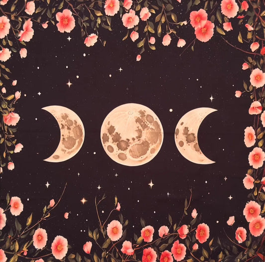 close up triple moon and pink flowers altar cloth.  background has stars and is a charcoal black moons are off white with dark and light browns 