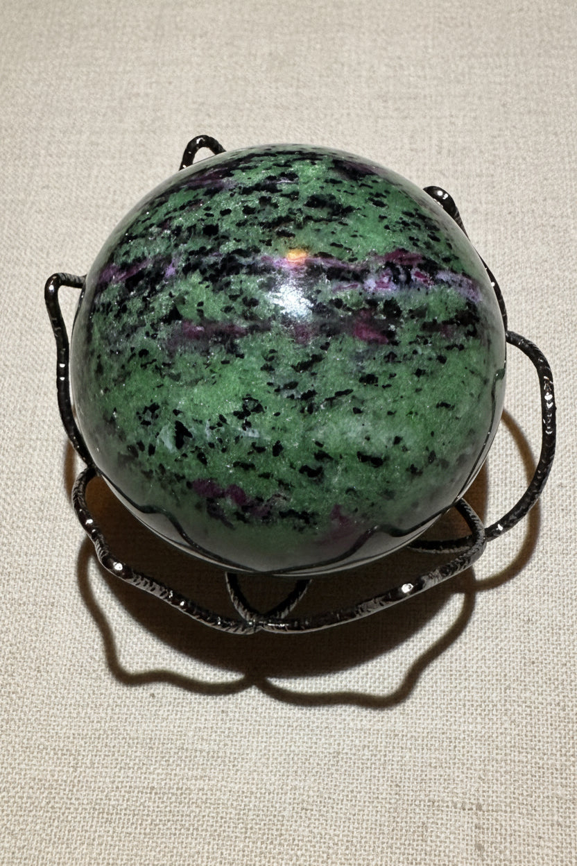 View 2 looking down at Ruby in Zoisite Sphere in a stand Bright greens and purples speckled on the sphere