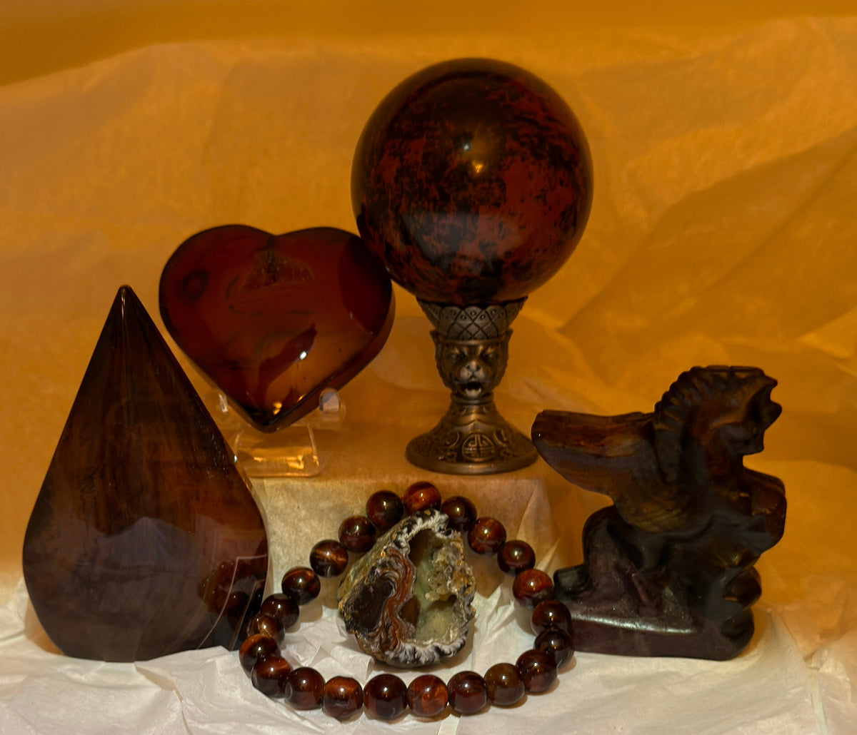Mahagony Obsidian Collector Set back side of carved heart, free form sphere with the small geode, elastic band 8 mm bead bracelet and a carved pegasus 