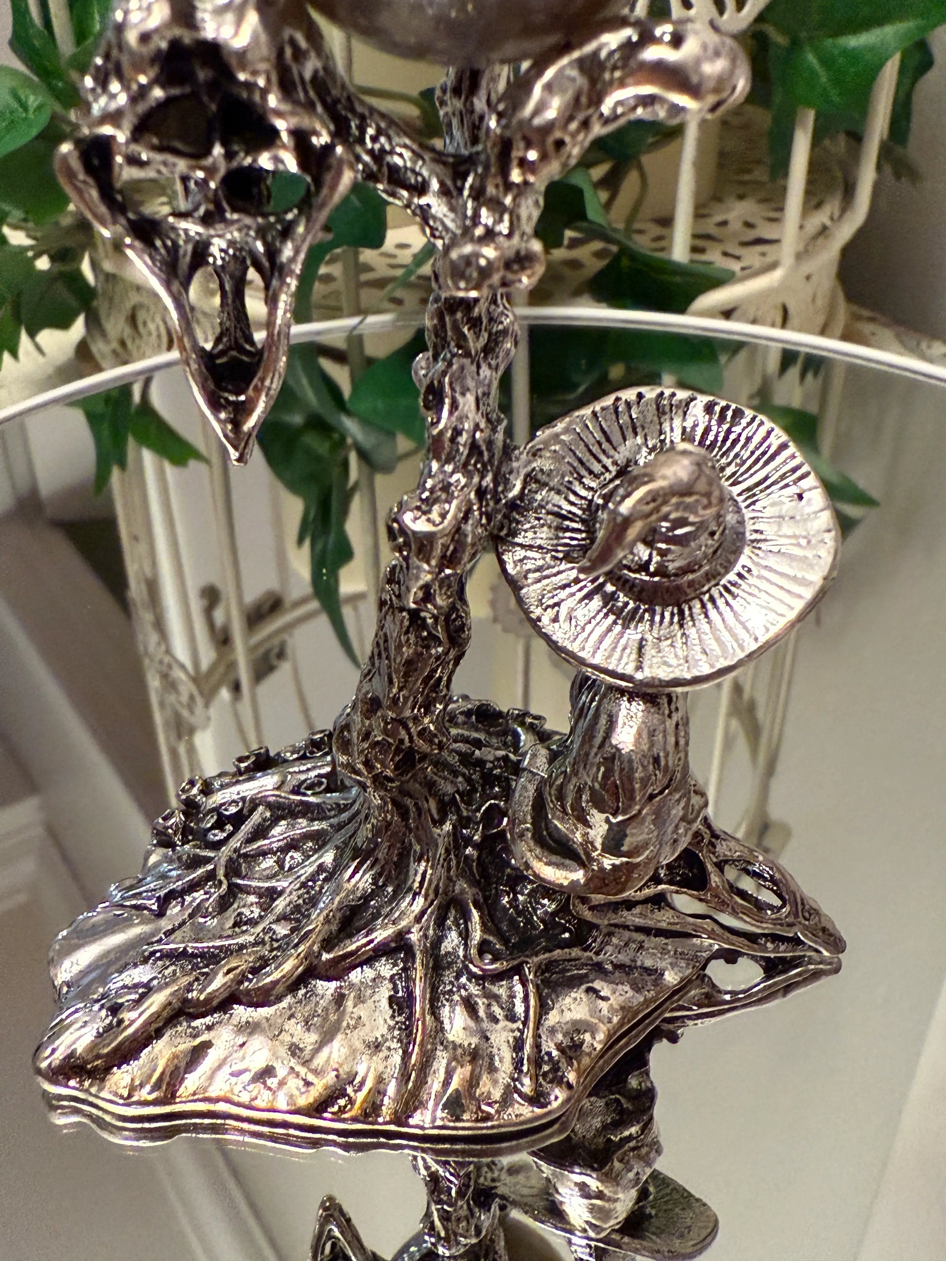 back side of silvery sphere stand showing witch hat and tree that holds sphere