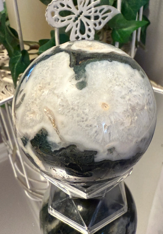 Moss Agate sphere with small druzy front view