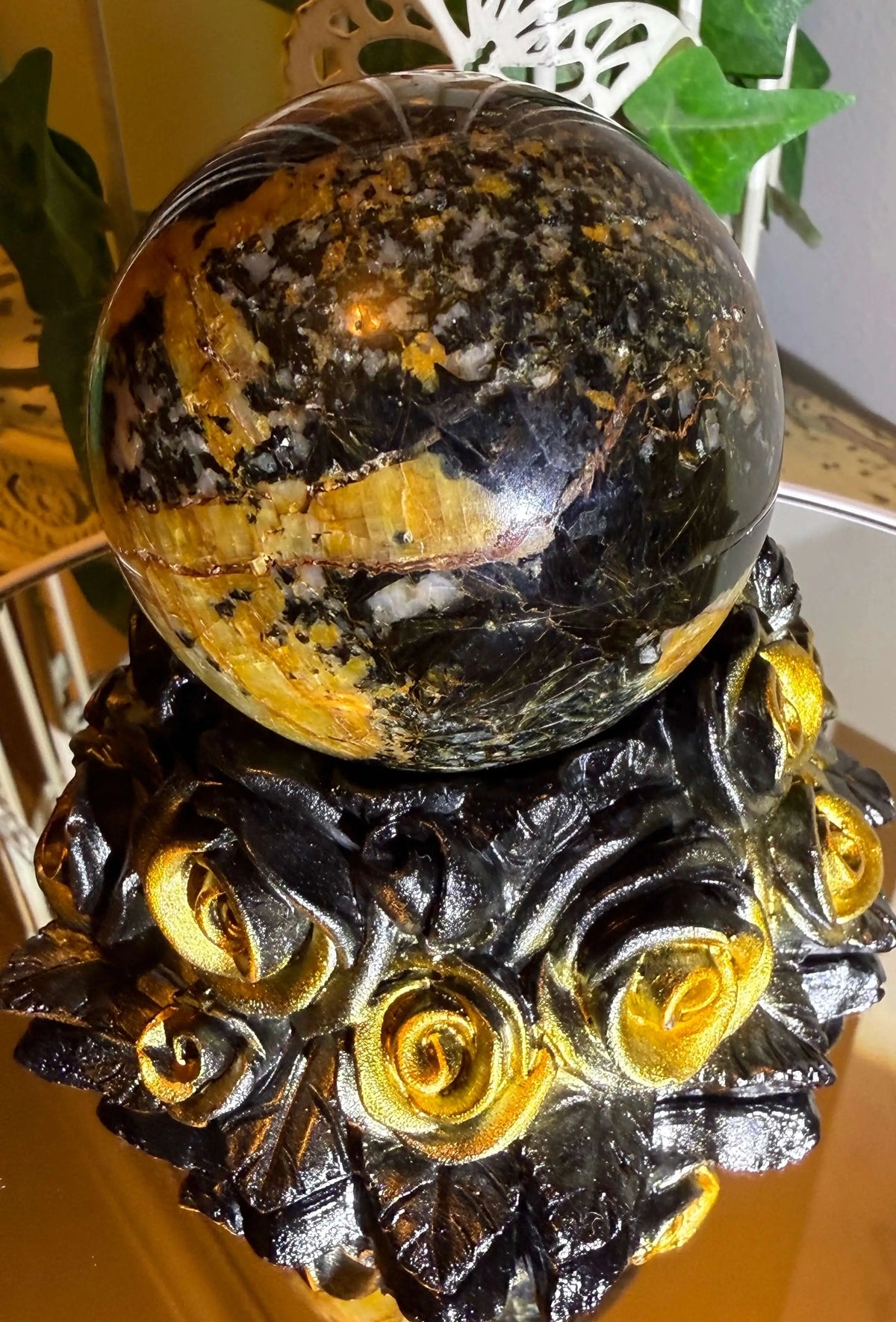 Pietersite crystal sphere with black gold rose stand front view