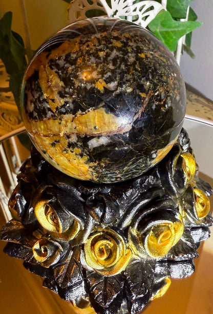 Pietersite crystal sphere with black gold rose stand front view