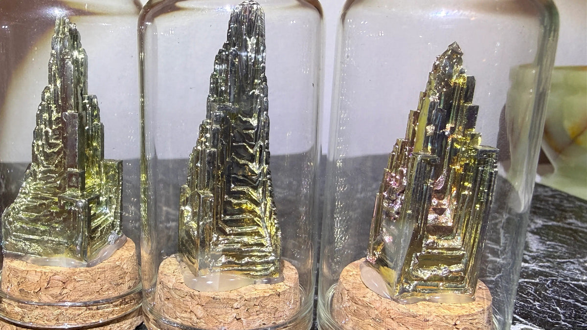 Close up bismuth towers in mini glass cloche display 