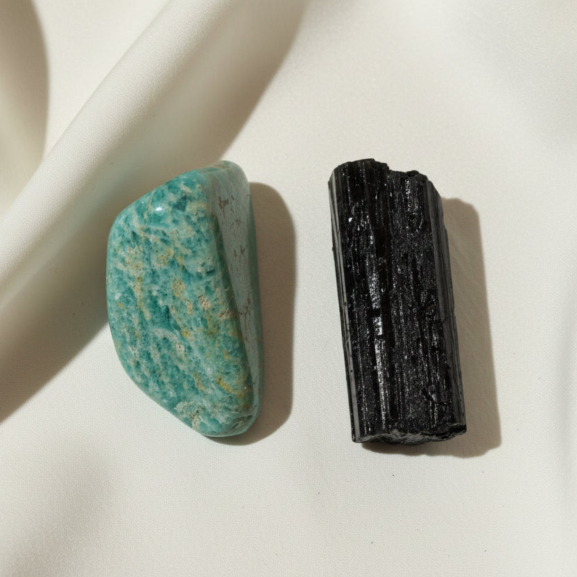 close up photo amazonite tumble and black tourmaline raw crystal teal blues and deep black colors
