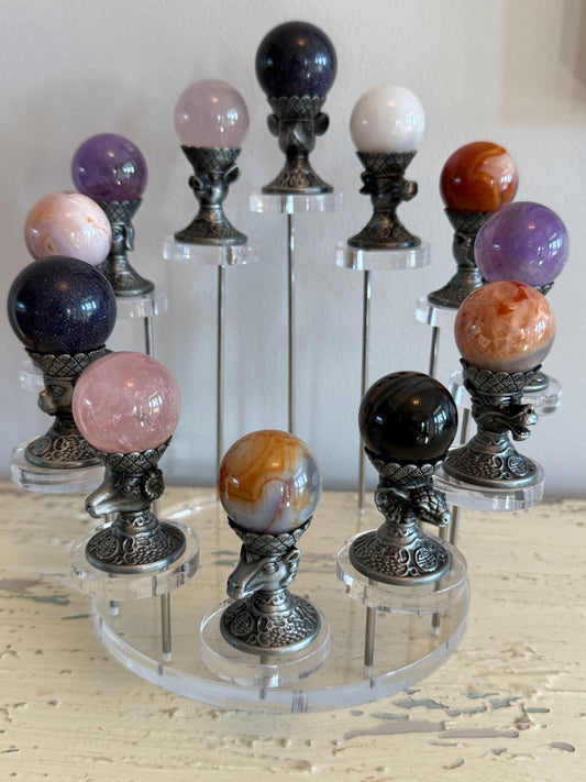 All 12 Zodiac Sphere Holders with crystal spheres on an acrylic stand