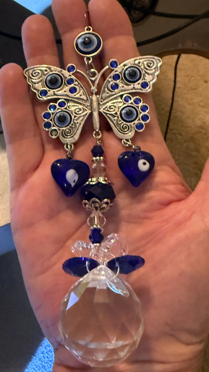 hand holding evil eye sun catcher 