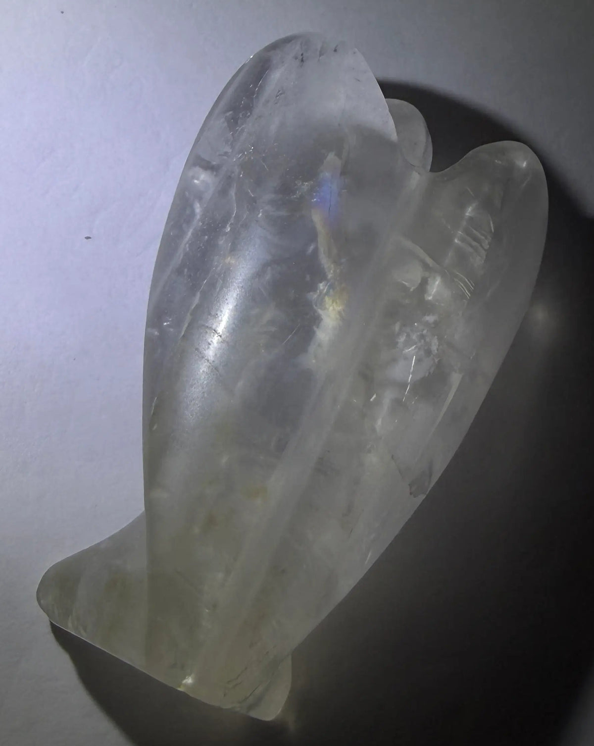 photo of the back side clear quartz carved angel with rainbow in the wing