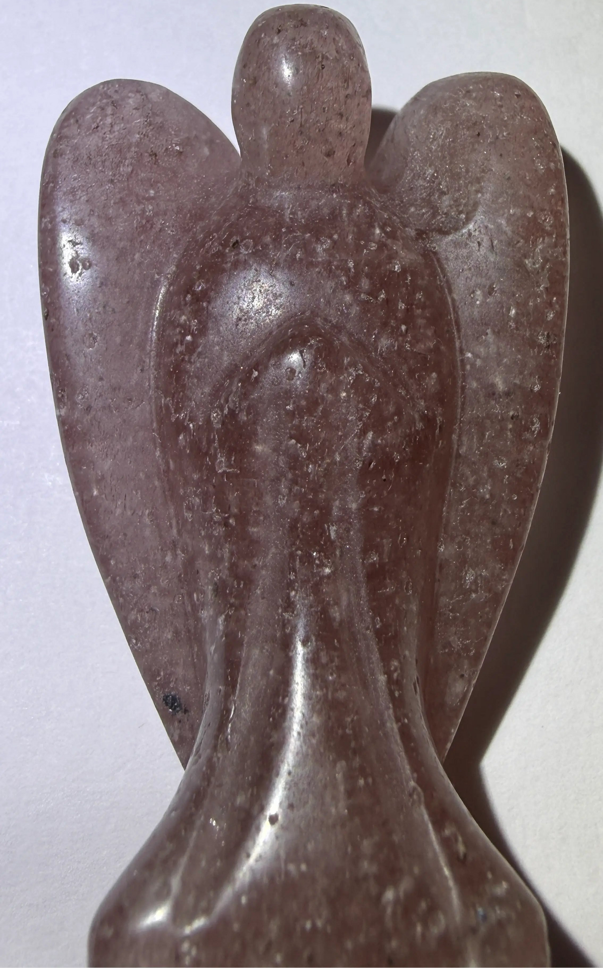 small angel carving from strawberry quartz crystal  soft pink
