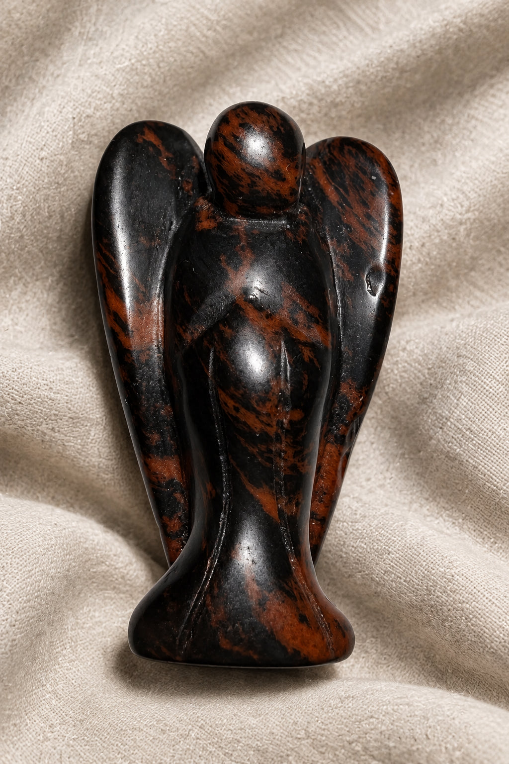 angel carved from mahogany obsidian beautiful black and deep copper colors throughout 