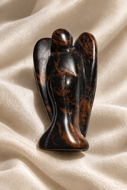 Side view of mahogany obsidian angel carving 