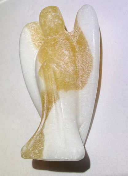 A carved angel figurine - close up side view. Orange calcite 