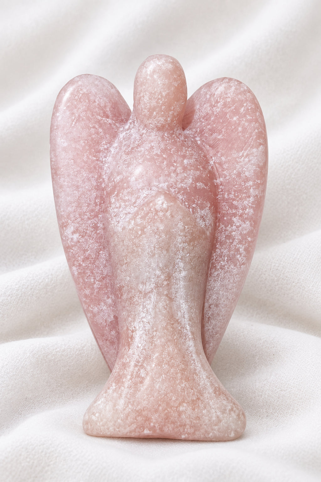 Small angel figurine carved from pink calcite crystal 