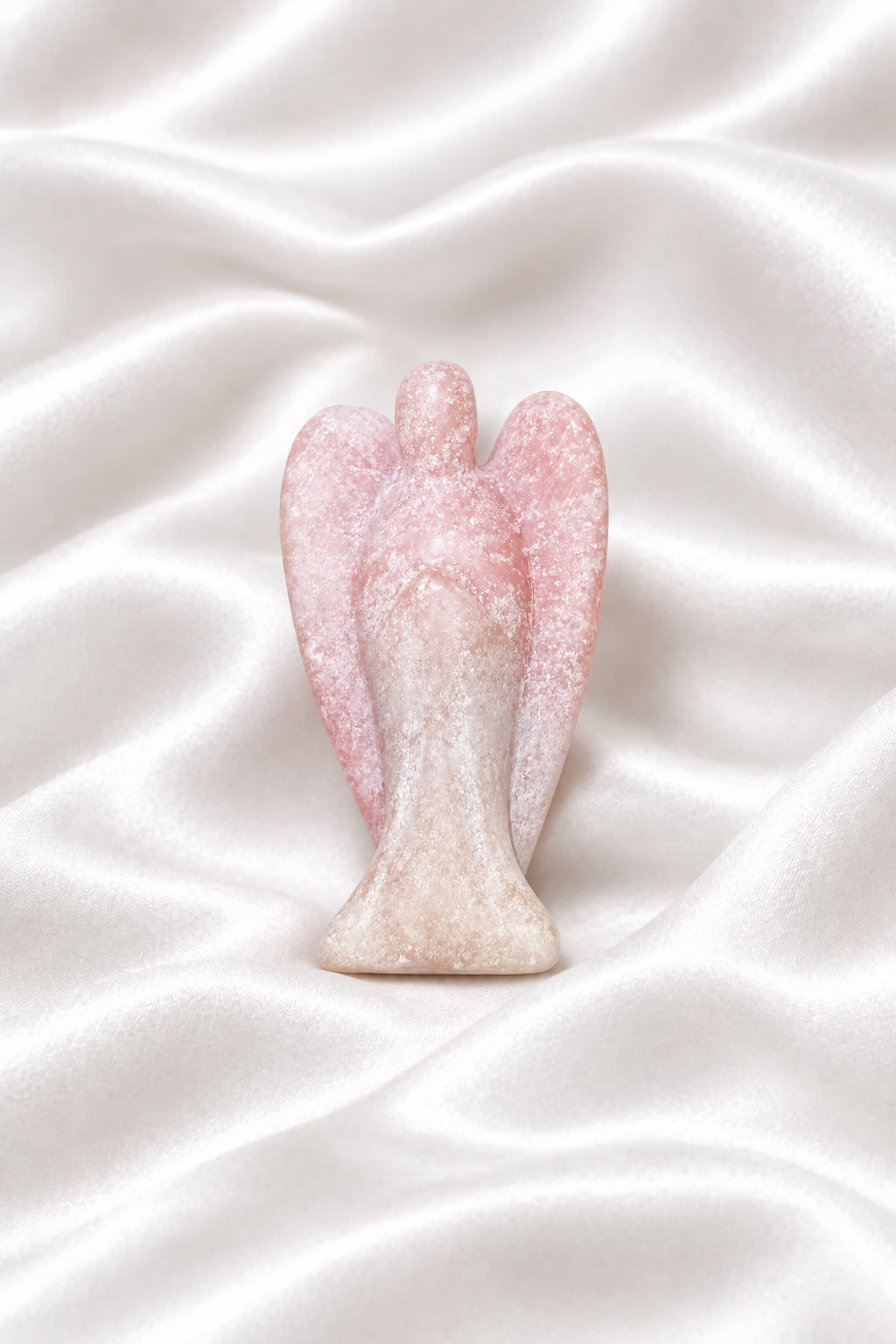 side view pink calcite hand carved angel