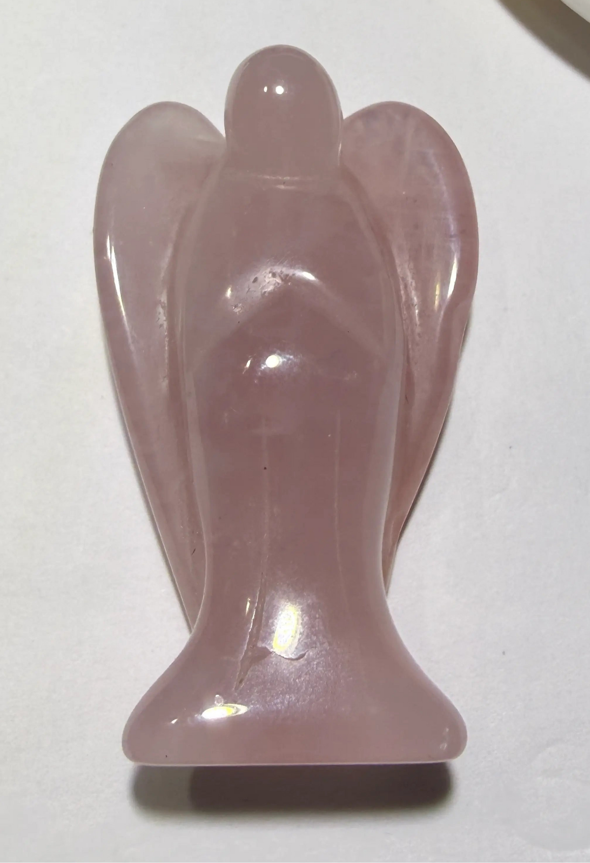 small angel carving from natural rose quartz crystal
