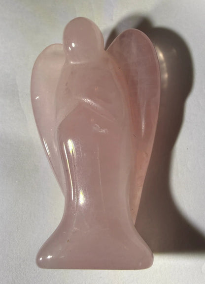 photo of side view of angel carved from natural and pure rose quartz crystal