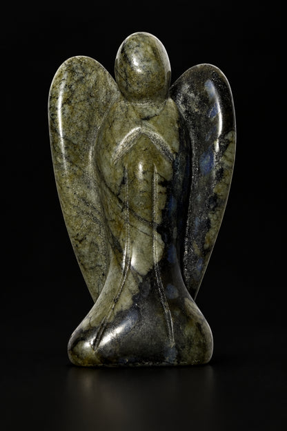 photo of natural larvikite carved angel figurine with a black background