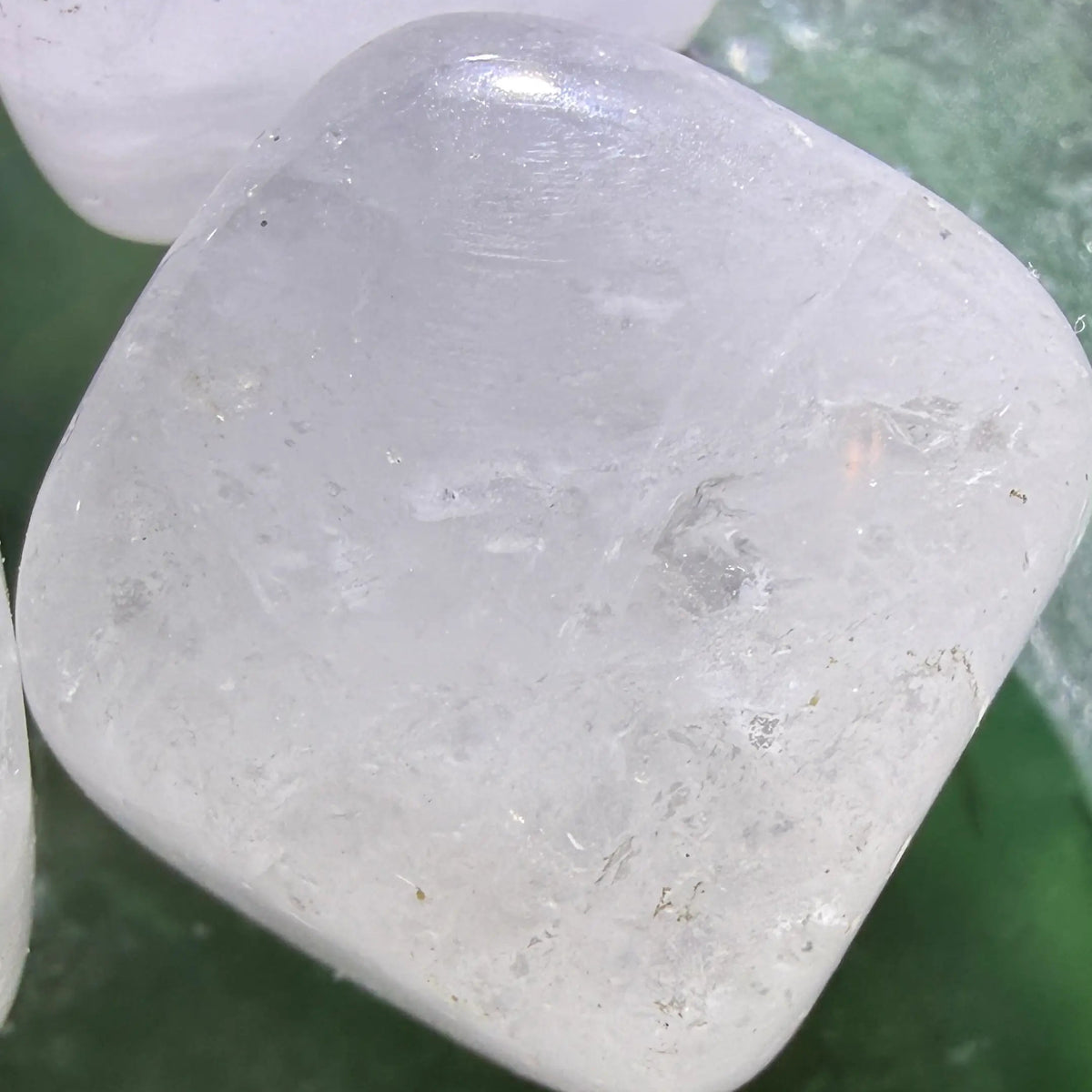 close up clear quartz carved cube, possible rutile inclusions