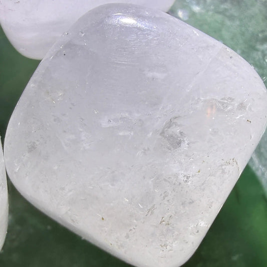 close up clear quartz carved cube, possible rutile inclusions