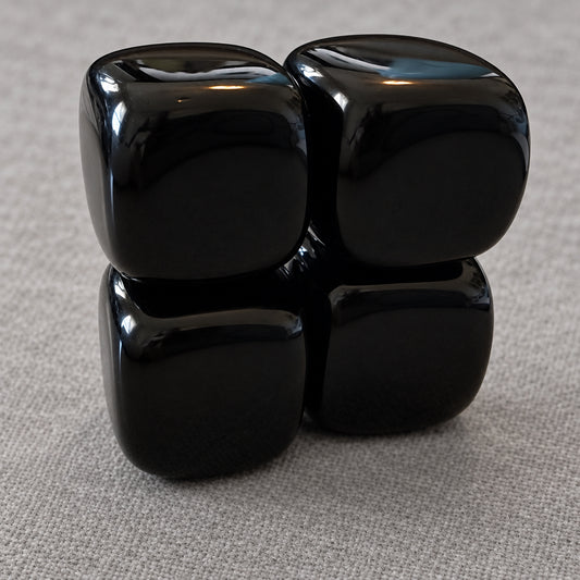 close up photo four black agate carved crystal cubes