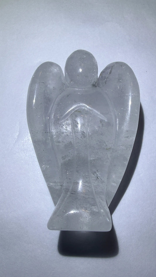 photo of clear quartz hand carved angel. photo shows trapped rutile inclusions