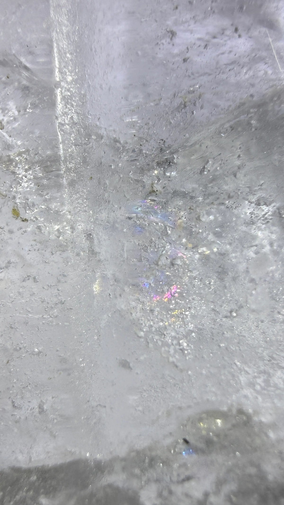 catch the rainbow - photo of clear quartz angel’s natural rainbow iridescence 