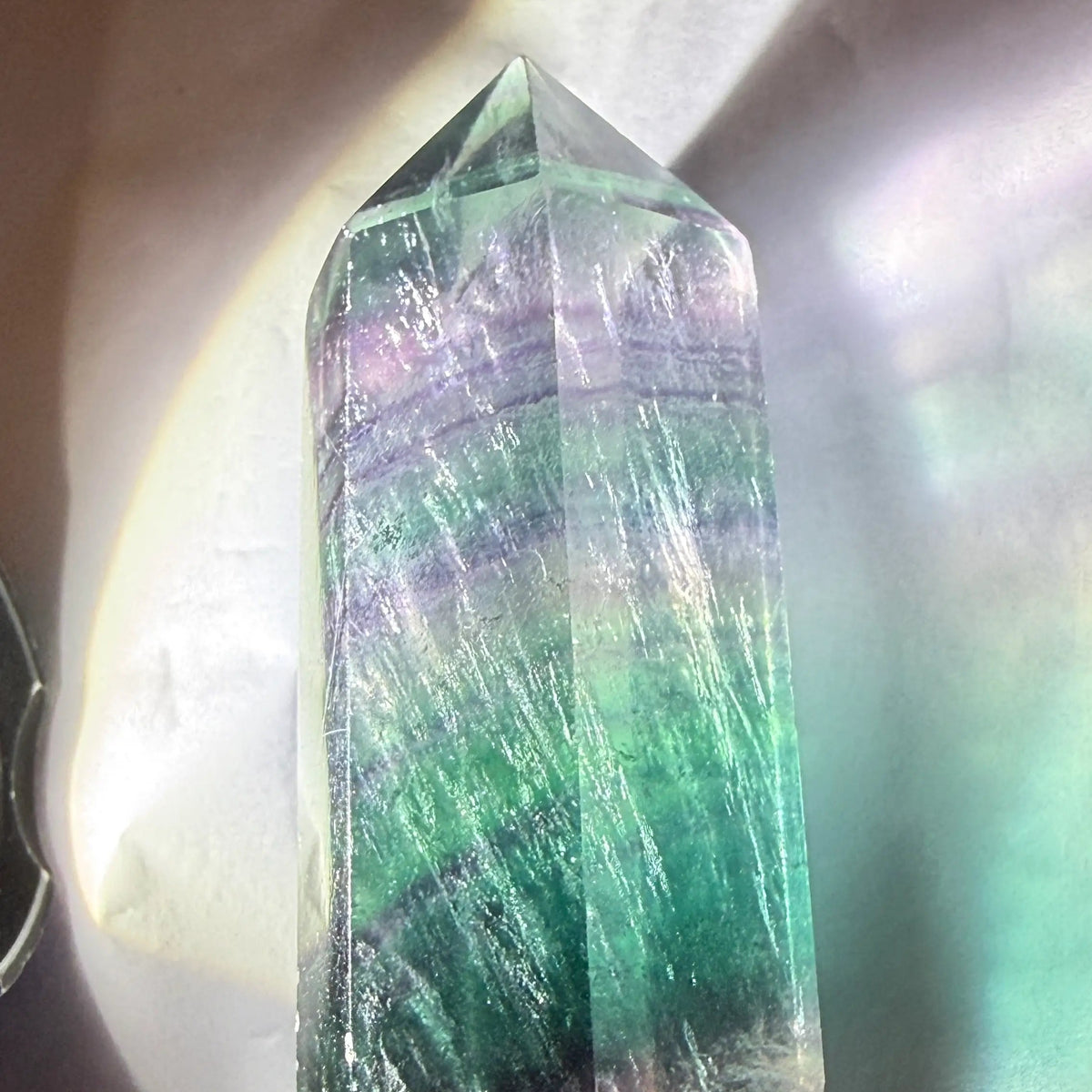 rainbow fluorite double point with light on 