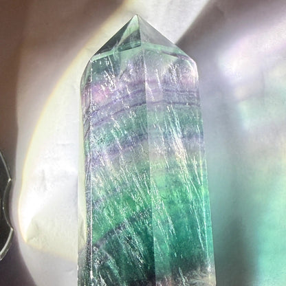 rainbow fluorite double point with light on 