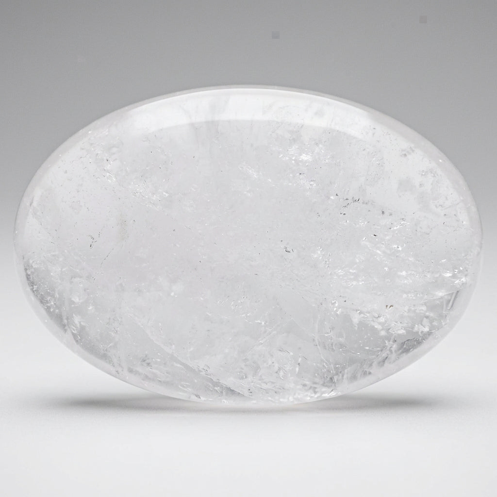 Close-up milky quartz palm stone rutile inclusions and natural rainbows