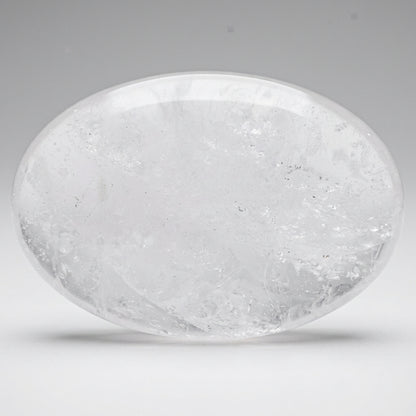 Close-up milky quartz palm stone rutile inclusions and natural rainbows