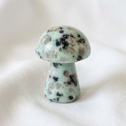 close up of a hand carved mushroom, made from kiwi jasper crystal