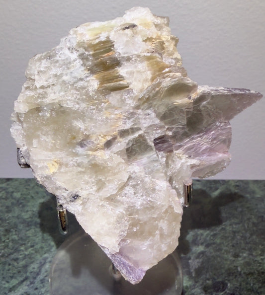 Lepidolite Crystal Specimen on a display stand 
