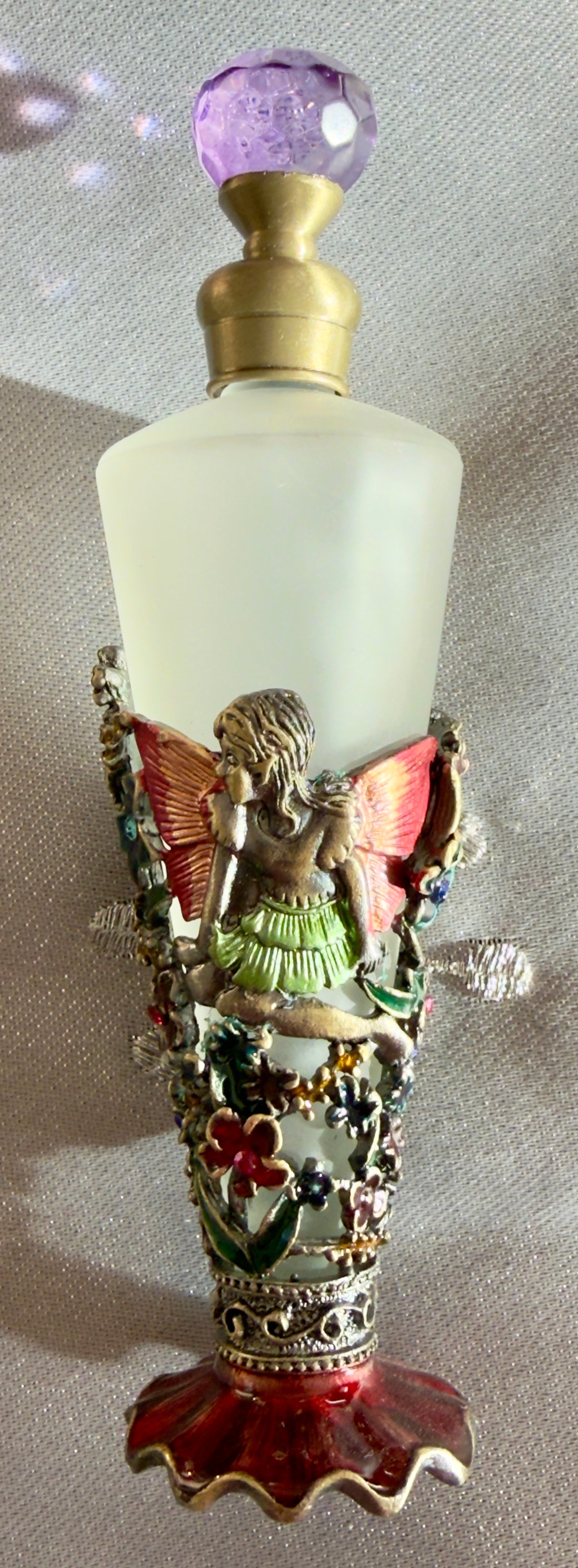 picture of beautiful frosted glass and metal design of fairy fragrance bottle