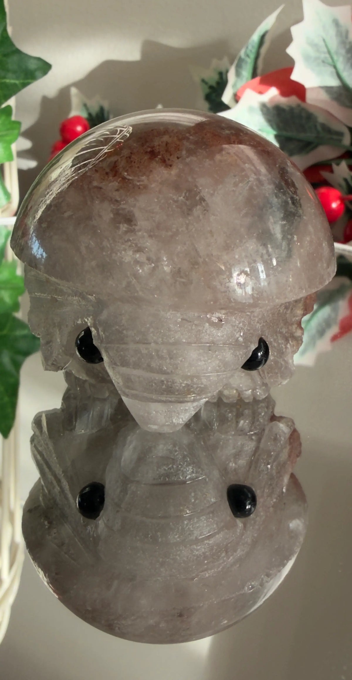 Close up of garden quartz carved elephant on a reflective surface