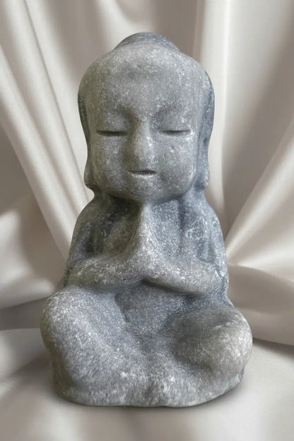 Tai Chi carved statue in seated meditation pose.

