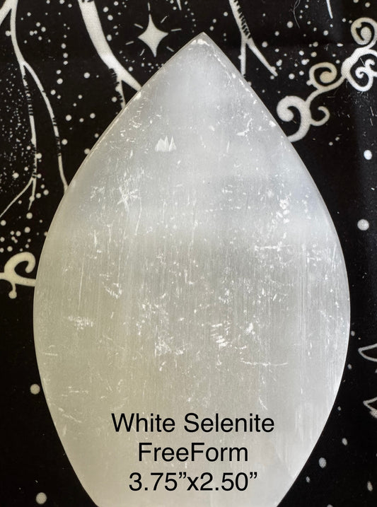 White selenite freeform crystal on patterned background.