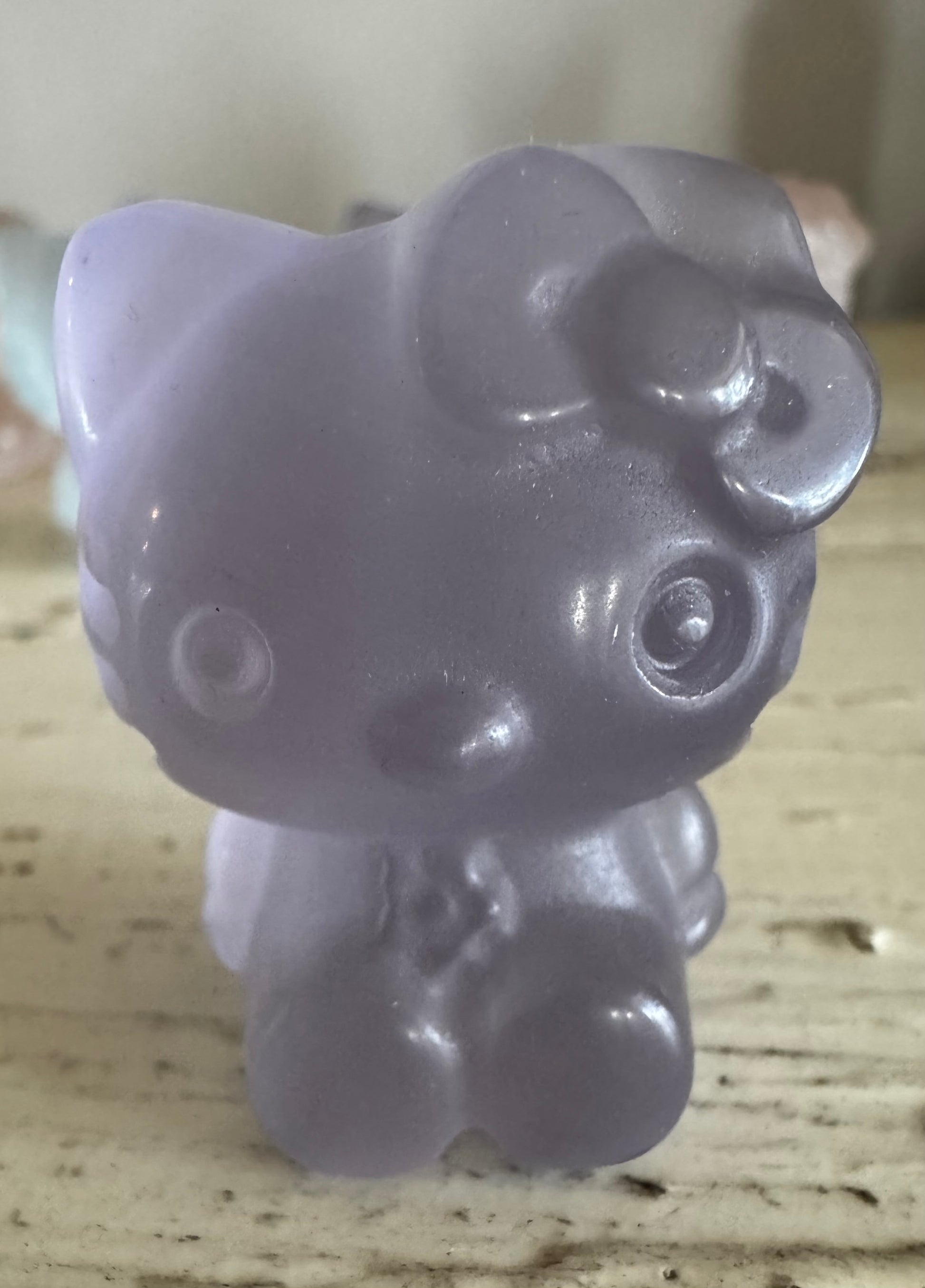 Close-up of a lavender Hello Kitty figurine.