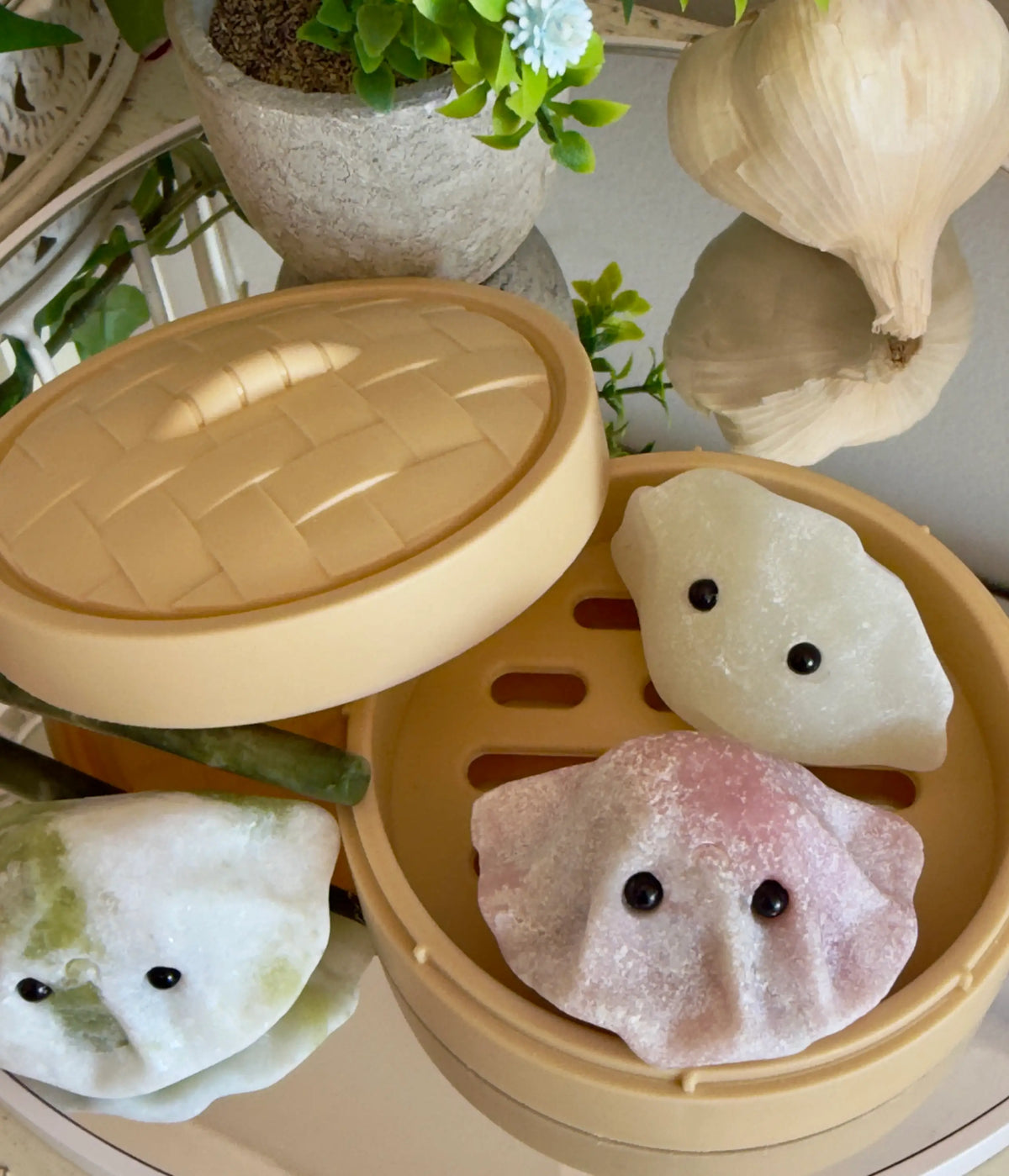 Asian Dumpling Steamer Basket C with colorful dumplings on a table