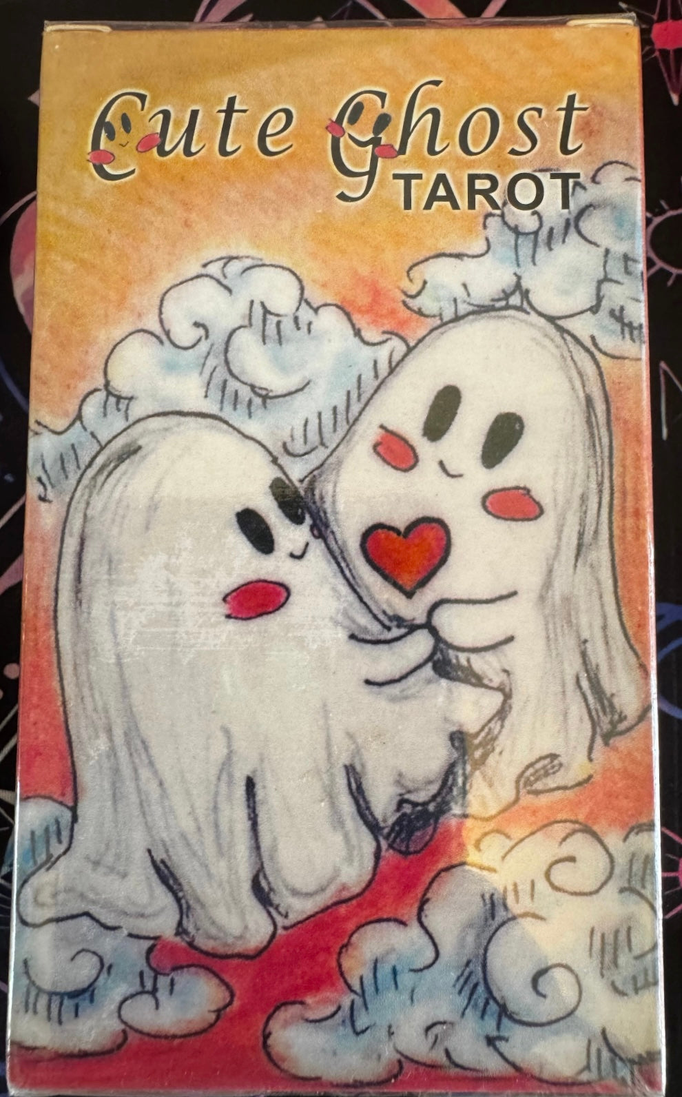 Box of "Cute Ghost Tarot" cards with illustration of two cartoon ghosts hugging.