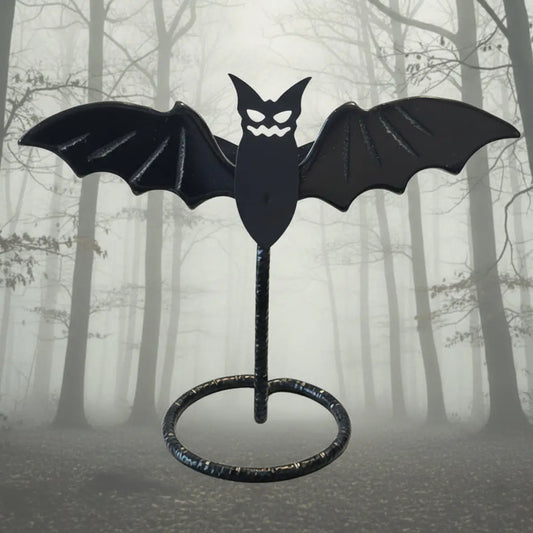 Black Obsidian Bat Wings Carving on a stand with spooky muted forest background
