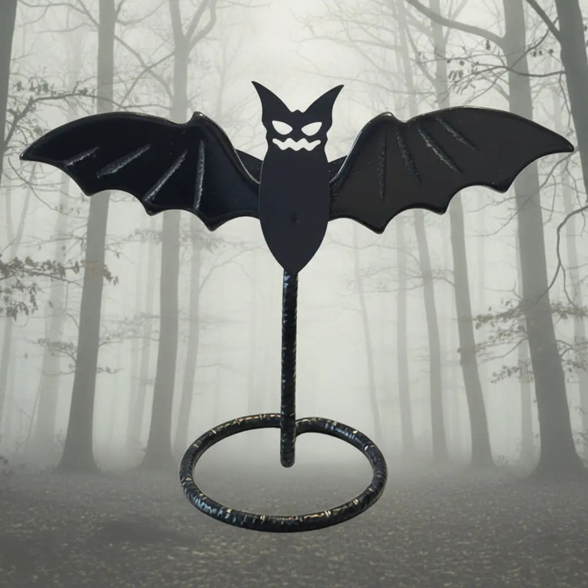 Black Obsidian Bat Wings Carving on a stand with spooky muted forest background