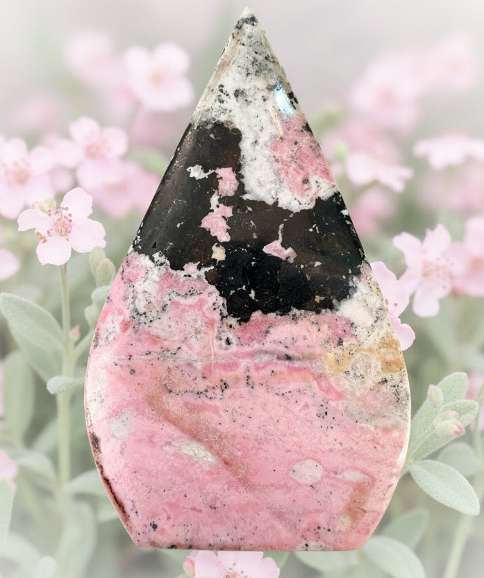 Rhodonite and Black Obsidian Love Bundle crystal in a teardrop shape surrounded by pink flowers