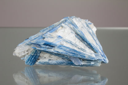 Close up of Blue Kyanite Specimen on a glass table 