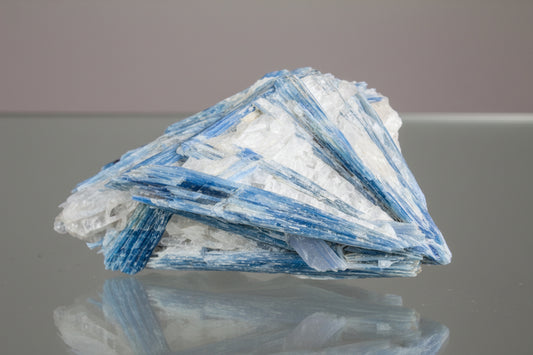 Close up of Blue Kyanite Specimen on a glass table 